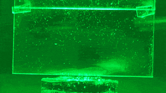 The puffs of white condensation on glass is water being evaporated from a hydrogel using green light, without heat.