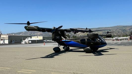 an Aska A5 flying car parked on a tarmac