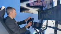 A man sitting in a chair in front of a tv.